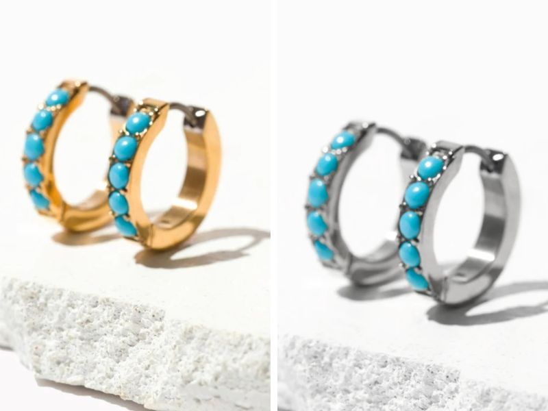Two pair of Alana turquoise titanium earrings made by Tini Lux. On the left are the gold earrings, and on the right are the silver (titanium). Both pairs are embedded with turquoise gemstones.