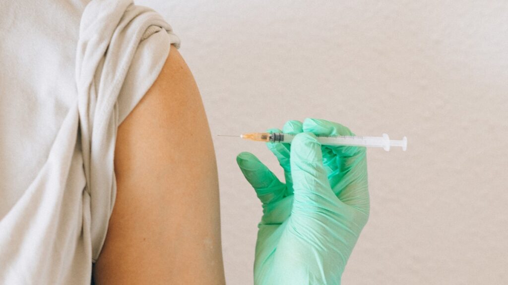 An adult getting an allergy shot in their left arm.