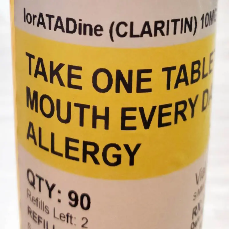 prescription bottle with a yellow label for loratadine, known as Claritin®. Label says: take one tablet by mouth every day for allergy, quantity 90