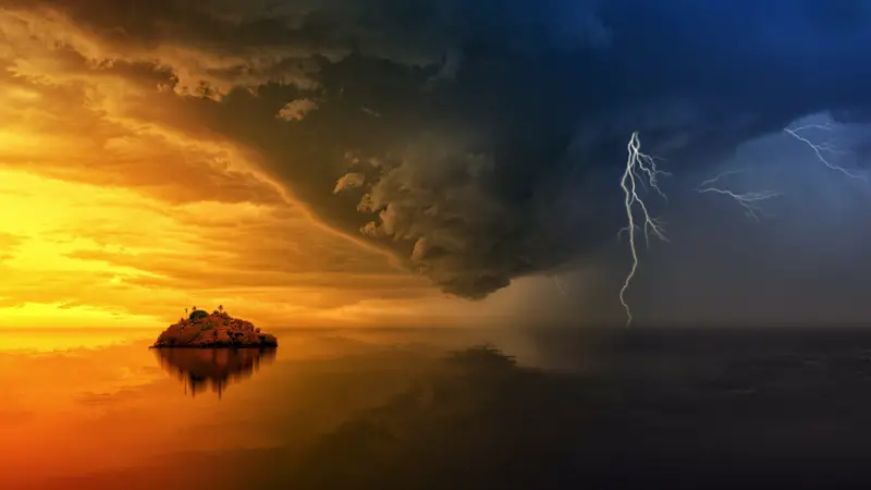 Extreme weather over water. On the left is bright orange skies, on the right is dark blue skies with lightening. Where the two colors meet is the start of a tornado.