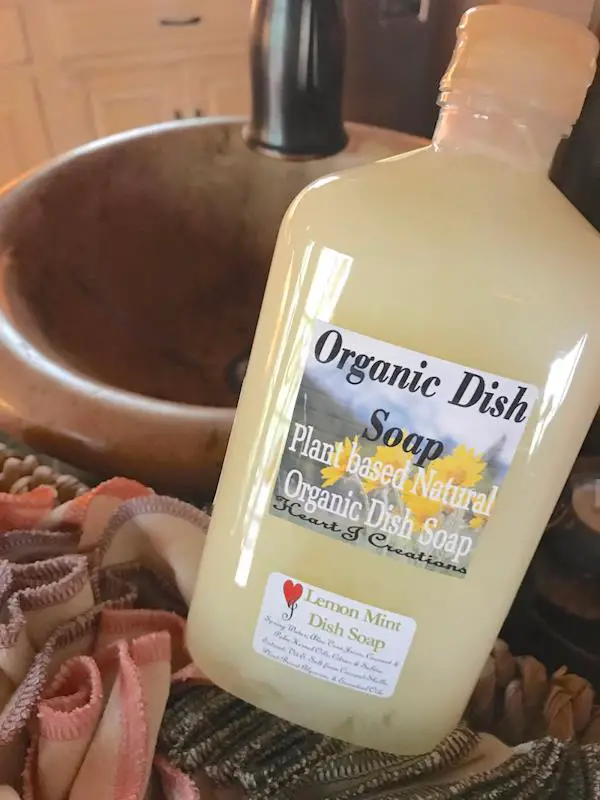 A container of plant based natural organic dish soap, lemon mint scented.