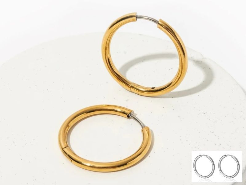 A classic pair of large hoop titanium earrings in gold.
