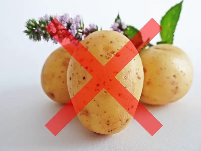 Three potatoes on a counter with a red "x" over the front, signifying no potatoes.