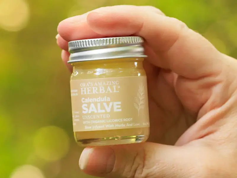A small jar of Ora's Amazing Herbal® Calendula Salve, unscented. This salve is ideal for conditions such as dry skin, eczema, and dermatitis.