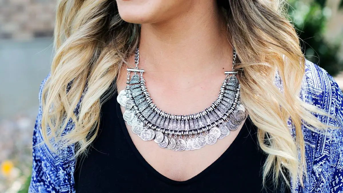 A woman wearing a large sterling silver necklace.