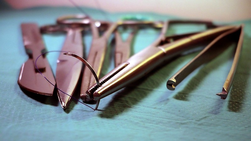 Surgical tools on a blue towel.