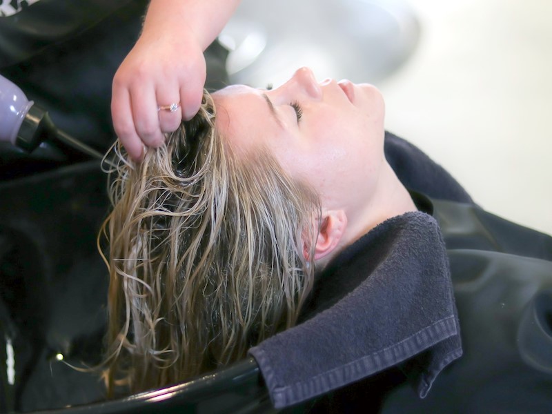 Woman getting her hair washed in a salon.