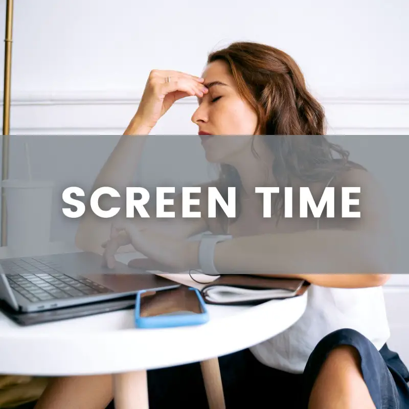 A woman holding her forehead like she has a tension headache. She is working on a laptop computer with a planner and cell phone on a table. Text across the image states "Screen Time"